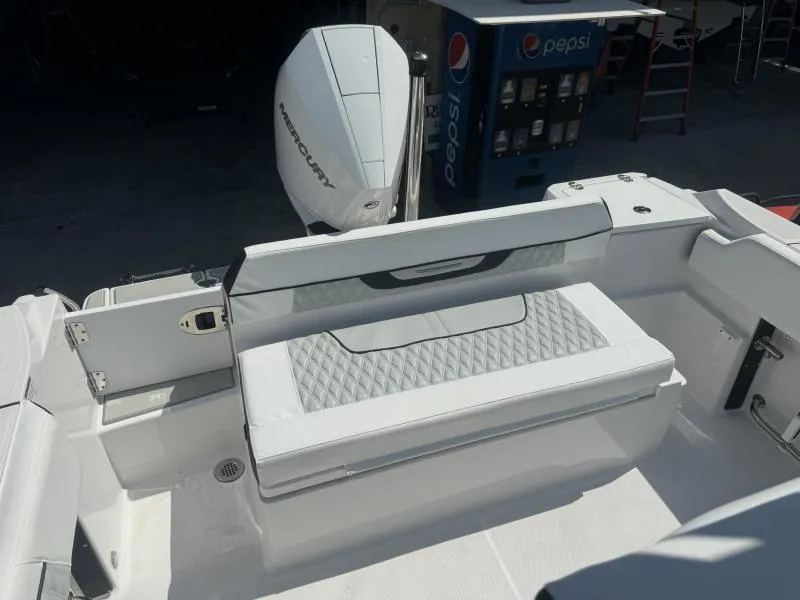 Slide: The Image of 2025 Blackfin 222 CC boat interior with Mercury engine and cushioned seating. - 13