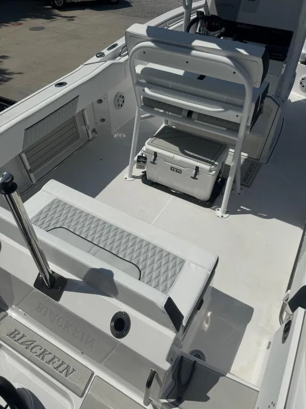 Slide: The Image of 2025 Blackfin 222 CC boat interior with seating and storage. - 14