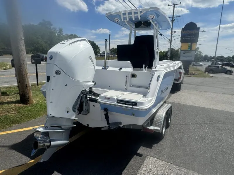 Slide: The Image of 2025 Blackfin 222 CC boat on trailer, featuring a powerful outboard motor. - 5