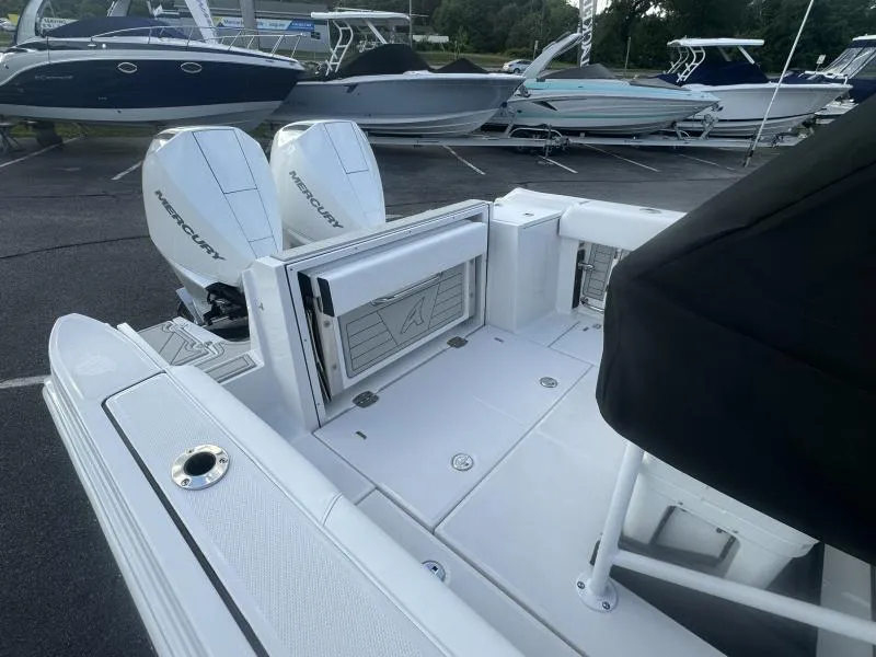 Slide: The Image of 2025 Blackfin 252 CC boat with dual Mercury engines in a marina setting. - 6