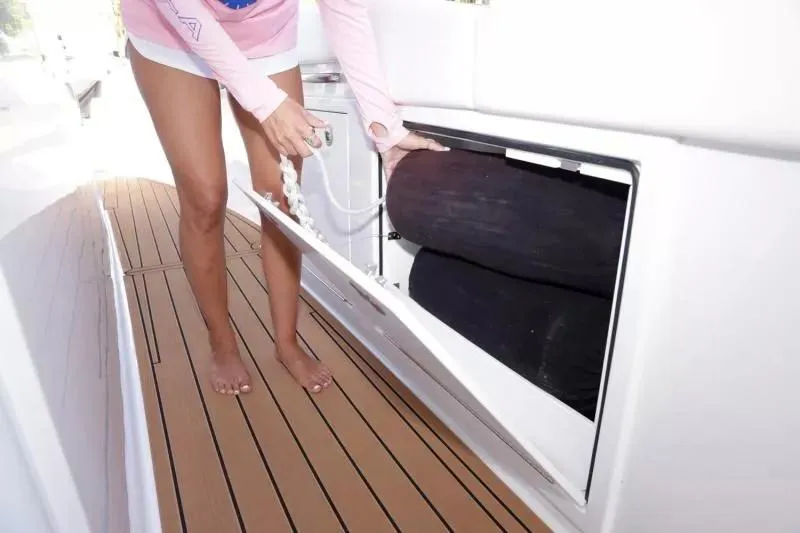 Slide: The Image of Person accessing storage on 2023 Formula 387 Center Console Fish boat. - 15