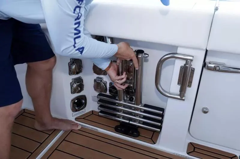 Slide: The Image of Person adjusting equipment on 2023 Formula 387 Center Console Fish boat deck. - 19
