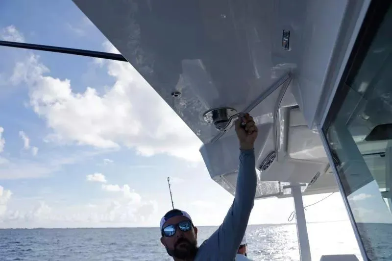 Slide: The Image of Man adjusting equipment on 2023 Formula 387 Center Console Fish boat at sea. - 21