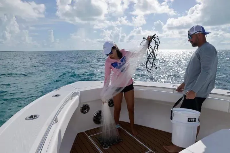 Slide: The Image of Two people fishing on a 2023 Formula 387 Center Console Fish boat. - 22