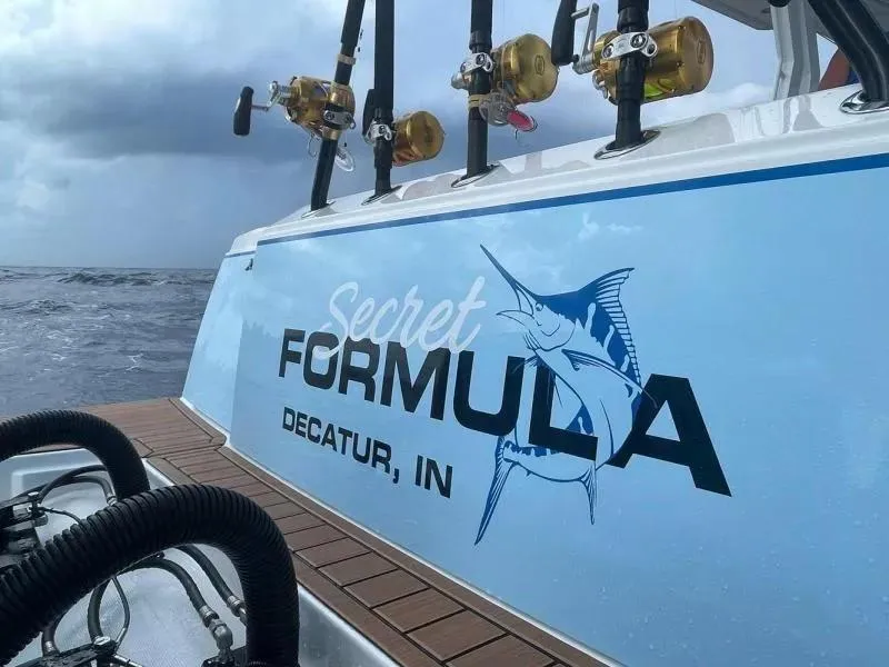 Slide: The Image of 2023 Formula 387 Center Console Fish boat with fishing rods, "Secret Formula" decal. - 8