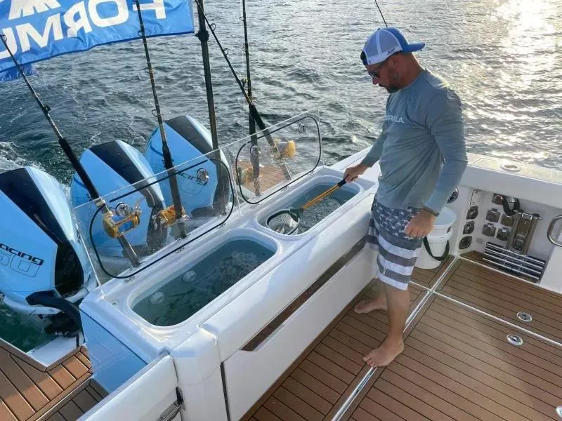 Slide: The Image of Man fishing on 2023 Formula 387 Center Console Fish boat with triple engines. - 9