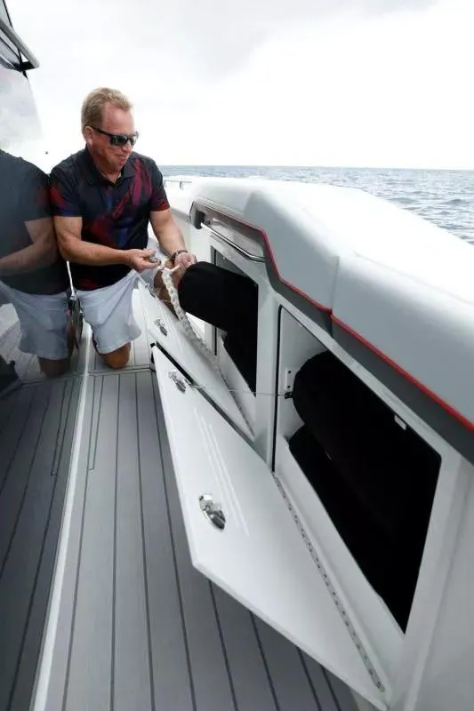Slide: The Image of Man organizing storage on 2023 Formula 387 Center Console Sport boat. - 10