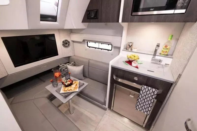 Slide: The Image of 2023 Formula 387 Center Console Sport interior with kitchenette and seating area. - 17