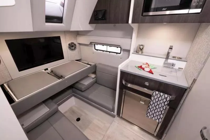 Slide: The Image of 2023 Formula 387 Center Console Sport interior with modern kitchen and seating area. - 18