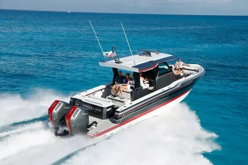 Slide: The Image of 2023 Formula 387 Center Console Sport boat cruising on clear blue ocean waters. - 2