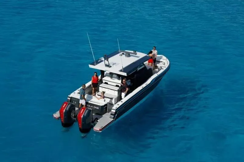Slide: The Image of 2023 Formula 387 Center Console Sport boat on clear blue water with passengers. - 3
