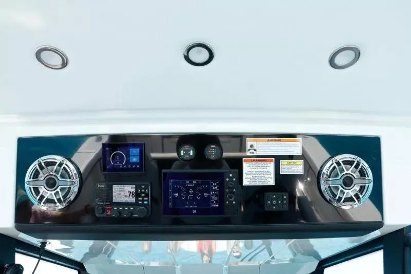 Slide: The Image of 2023 Formula 387 Center Console Sport dashboard with modern controls and speakers. - 8