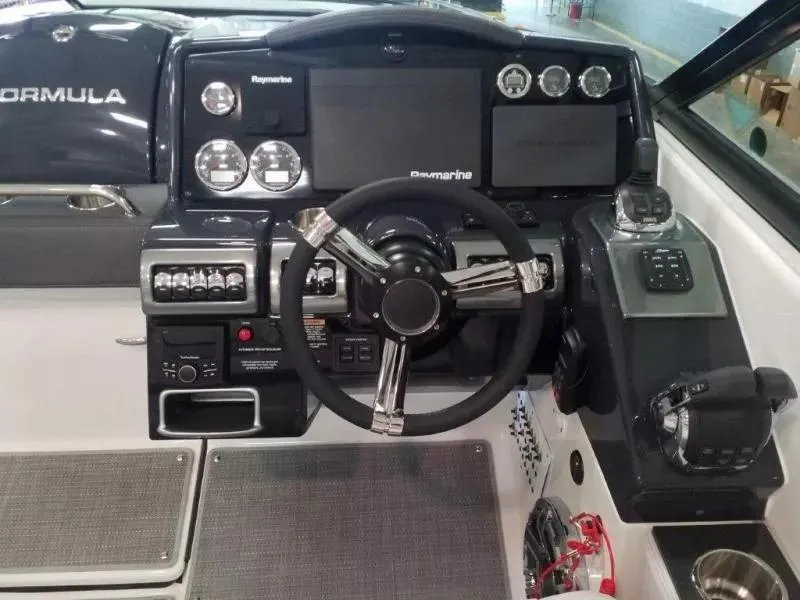 Slide: The Image of 2021 Formula 350 Crossover Bowrider dashboard with steering wheel and navigation controls. - 18