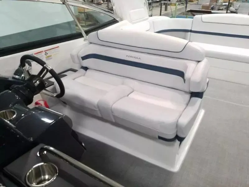 Slide: The Image of 2021 Formula 350 Crossover Bowrider interior with white seating and steering wheel. - 19