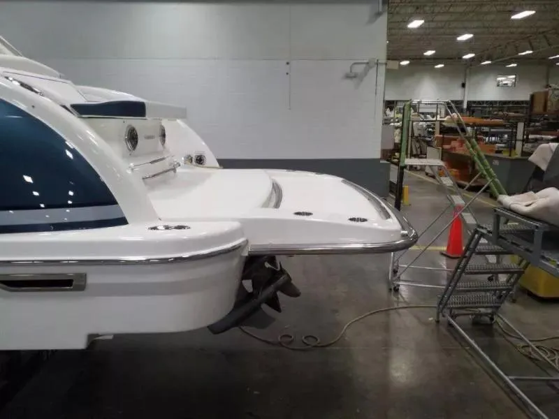 Slide: The Image of 2021 Formula 350 Crossover Bowrider in a warehouse, showcasing its sleek design and swim platform. - 24