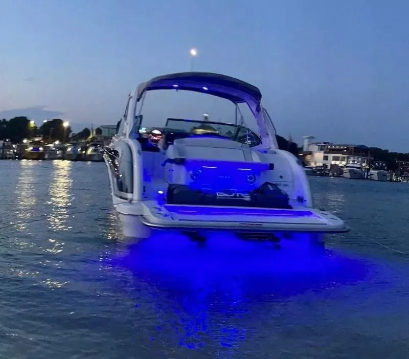 Slide: The Image of 2021 Formula 350 Crossover Bowrider with blue underwater lights at dusk. - 3