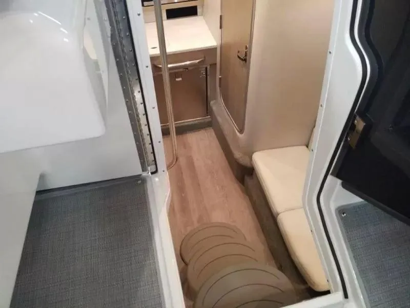 Slide: The Image of Interior view of 2021 Formula 350 Crossover Bowrider, featuring seating and cabinetry. - 9