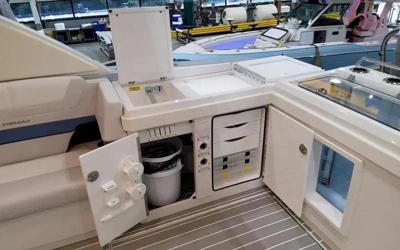 Slide: The Image of 2024 Formula 430 All Sport Crossover yacht interior with kitchenette and storage compartments. - 13