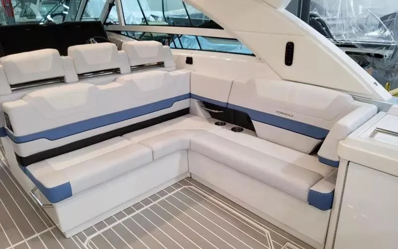 Slide: The Image of 2024 Formula 430 All Sport Crossover boat interior with white and blue seating. - 14