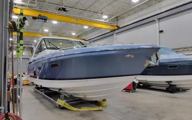 Slide: The Image of 2024 Formula 430 All Sport Crossover boat in a warehouse setting. - 2
