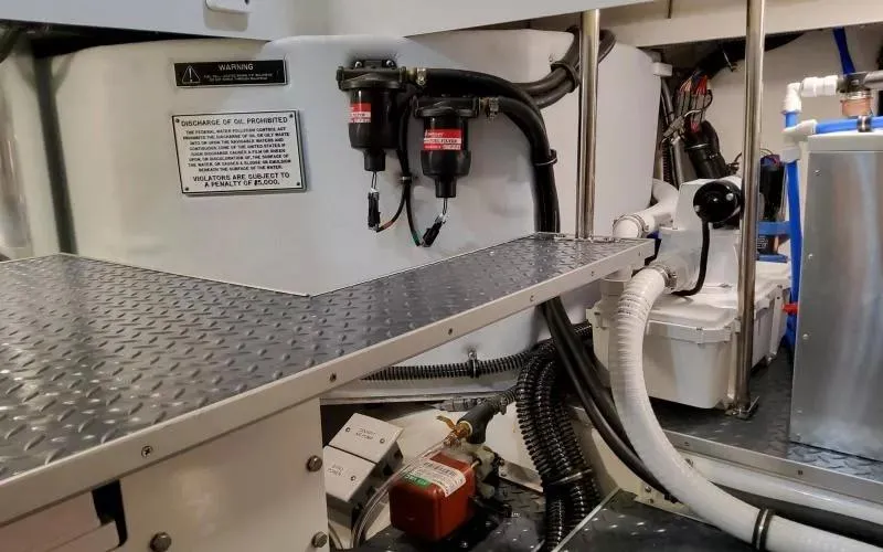 Slide: The Image of Engine room of 2024 Formula 430 All Sport Crossover with mechanical components and warning signs. - 24