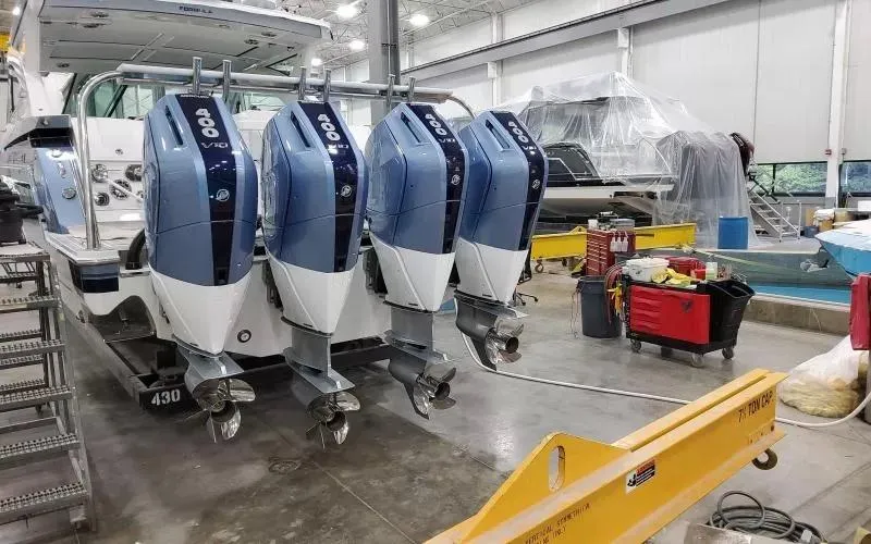 Slide: The Image of 2024 Formula 430 All Sport Crossover with quad outboard engines in a workshop setting. - 5