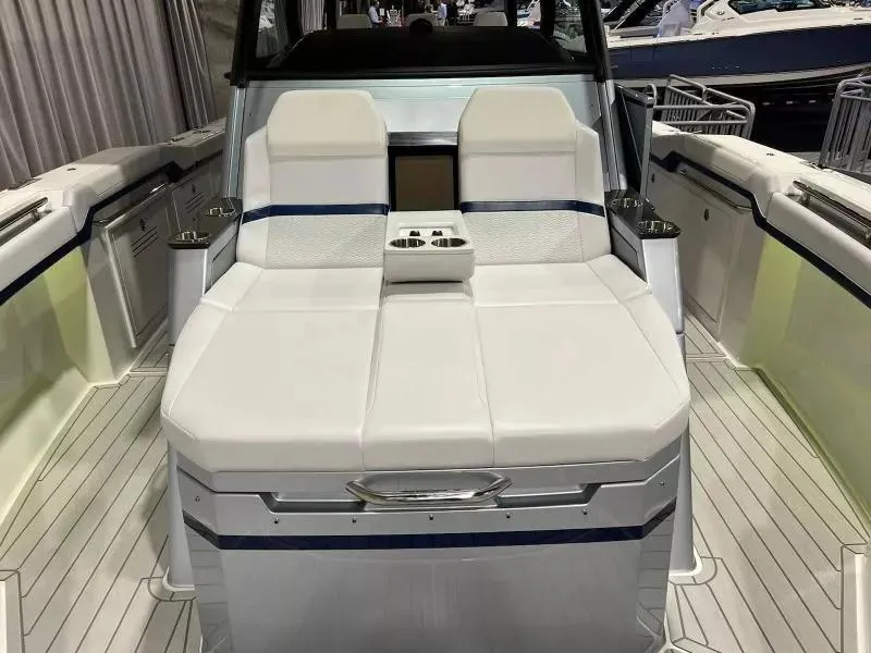 Slide: The Image of 2023 Formula 387 Center Console Sport boat with luxurious white seating and cup holders. - 11