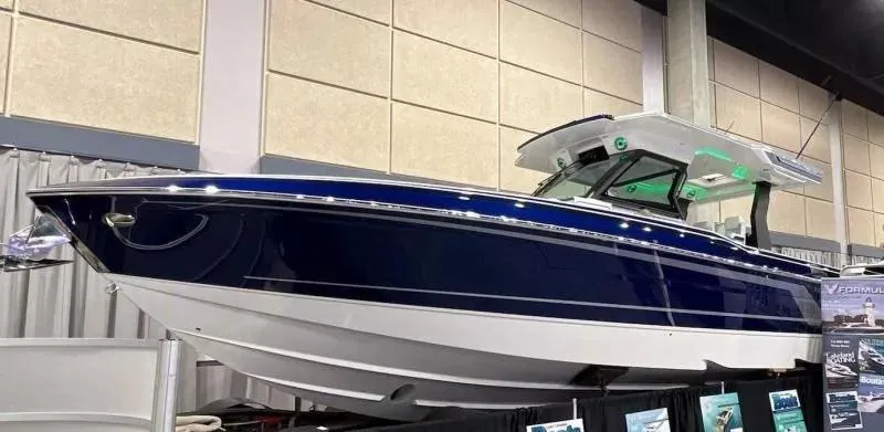 Slide: The Image of 2023 Formula 387 Center Console Sport boat displayed indoors at a boat show. - 2