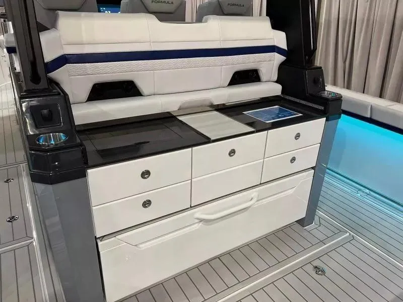 Slide: The Image of 2023 Formula 387 Center Console Sport interior with sleek seating and storage drawers. - 6