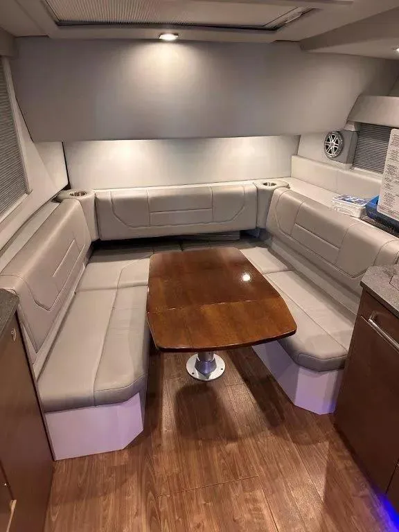 Slide: The Image of Interior of 2017 Formula 430 Super Sport Crossover with plush seating and wooden table. - 16