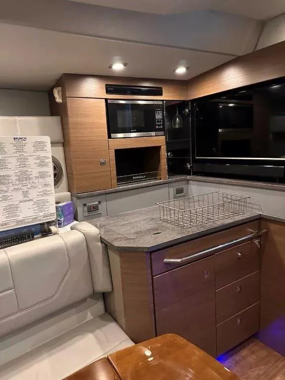 Slide: The Image of Interior of 2017 Formula 430 Super Sport Crossover yacht kitchen area with modern amenities. - 17