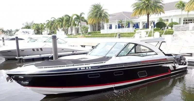 Slide: The Image of 2017 Formula 430 Super Sport Crossover yacht docked at marina with palm trees. - 2