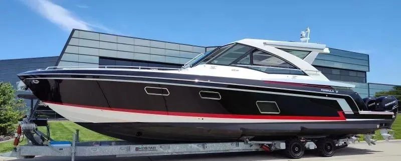 Slide: The Image of 2017 Formula 430 Super Sport Crossover boat on trailer, sleek design, modern building backdrop. - 4