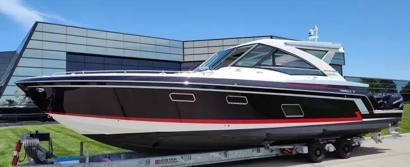 Slide: The Image of 2017 Formula 430 Super Sport Crossover boat on trailer, sleek design, modern building backdrop. - 5