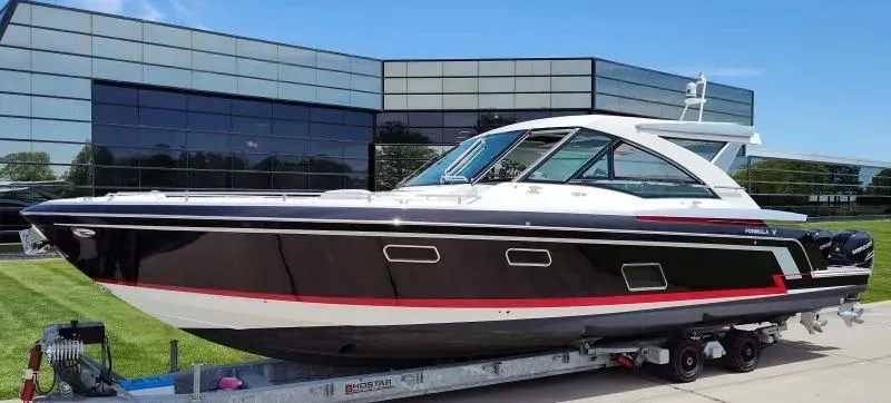 Slide: The Image of 2017 Formula 430 Super Sport Crossover boat on trailer, modern building background. - 7