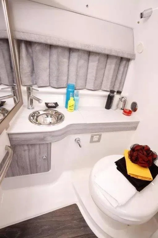 Slide: The Image of 2023 Formula 310 Sun Sport bathroom with sink, toiletries, and towels. - 6