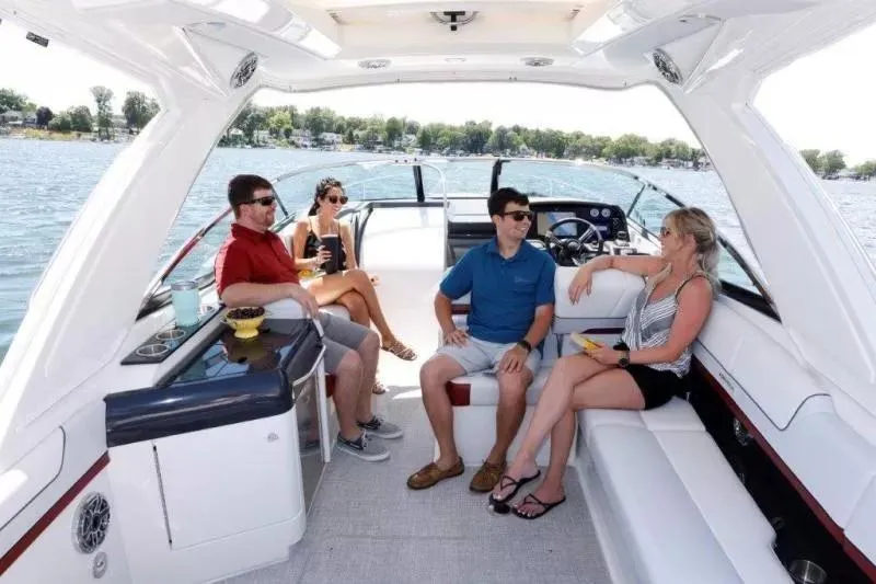 Slide: The Image of 2023 Formula 310 Sun Sport boat with people relaxing on deck, enjoying a sunny day on the water. - 7