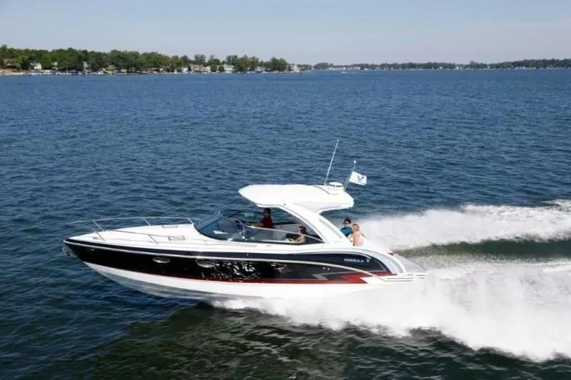 Slide: The Image of 2023 Formula 310 Sun Sport cruising on a lake, creating a wake behind. - 9