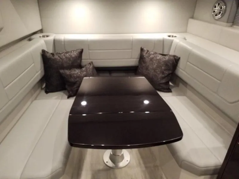 Slide: The Image of 2019 Formula 430 Super Sport Crossover interior with sleek table and cushioned seating. - 11