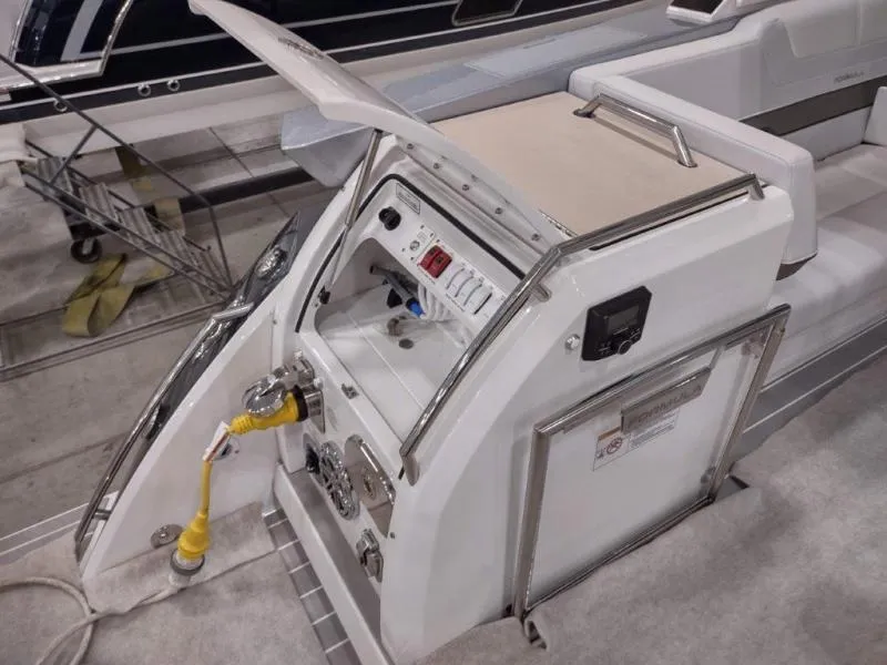 Slide: The Image of 2019 Formula 430 Super Sport Crossover boat control panel with open hatch and electrical connections. - 19
