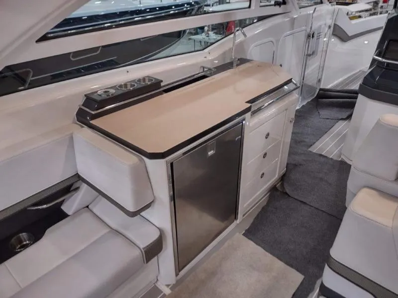 Slide: The Image of 2019 Formula 430 Super Sport Crossover interior with kitchenette and seating area. - 22