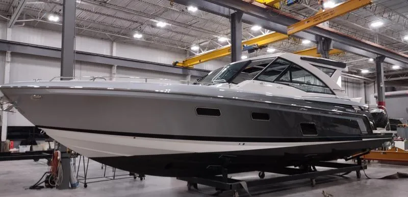 Slide: The Image of 2019 Formula 430 Super Sport Crossover boat in a spacious indoor facility. - 3