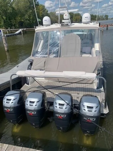 Slide: The Image of 2019 Formula 430 Super Sport Crossover with four powerful outboard motors docked at a marina. - 4