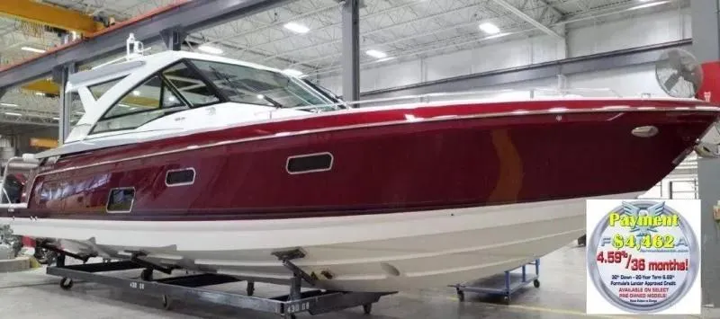 Slide: The Image of 2020 Formula 430 Super Sport Crossover boat in showroom, red and white exterior. - 1