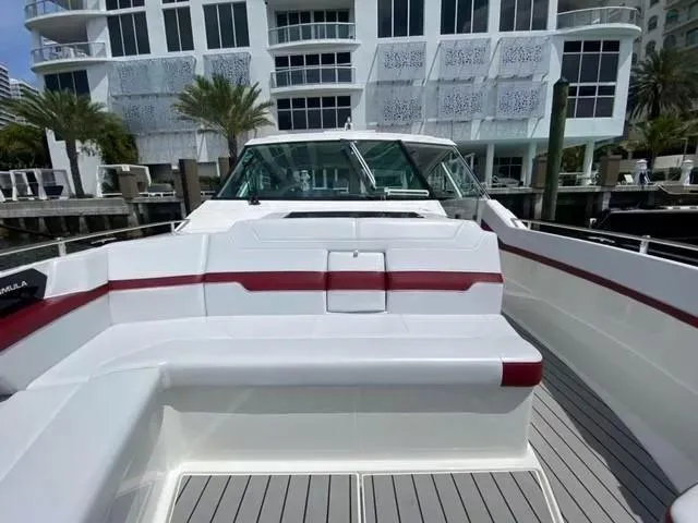 Slide: The Image of 2020 Formula 430 Super Sport Crossover boat docked near modern building. - 10