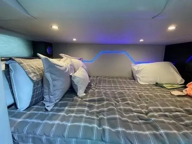 Slide: The Image of Cozy cabin interior of 2020 Formula 430 Super Sport Crossover with modern bedding and ambient lighting. - 17