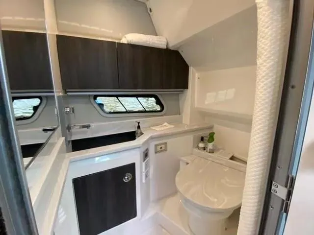 Slide: The Image of 2020 Formula 430 Super Sport Crossover bathroom with modern fixtures and sleek cabinetry. - 18