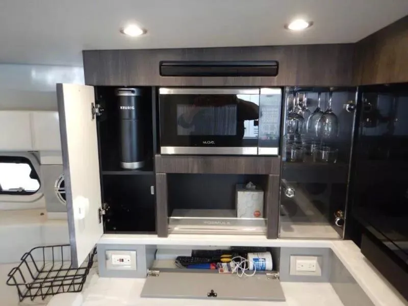 Slide: The Image of Modern kitchen area in 2020 Formula 430 Super Sport Crossover yacht with microwave and storage. - 20