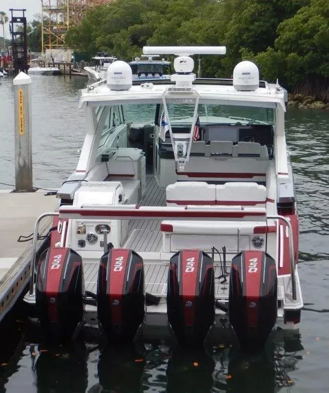 Slide: The Image of 2020 Formula 430 Super Sport Crossover boat docked with four powerful engines. - 5