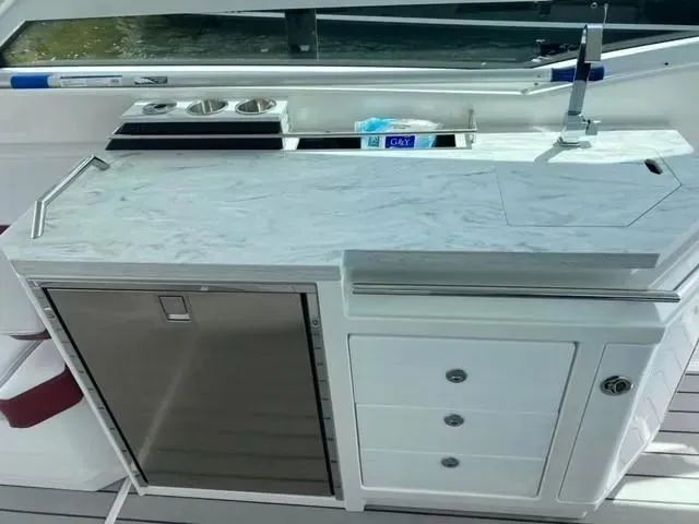 Slide: The Image of 2020 Formula 430 Super Sport Crossover boat kitchenette with sink, storage, and countertop. - 6